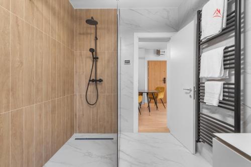 a bathroom with a shower and a walk in shower at Apartament 1 C4 Grand Chalet Poiana Brasov in Braşov