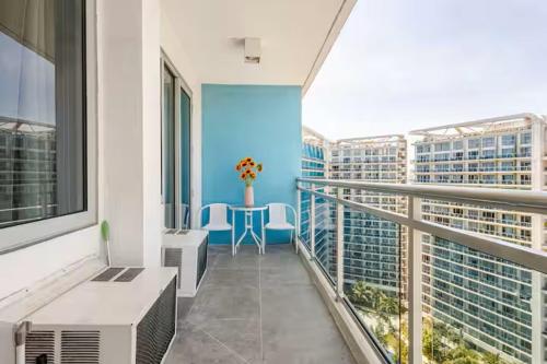 a balcony with a table and chairs in a building at Sabrina'sCrib Apartment 2BR by Azure Residences Near Manila International Airport in Manila