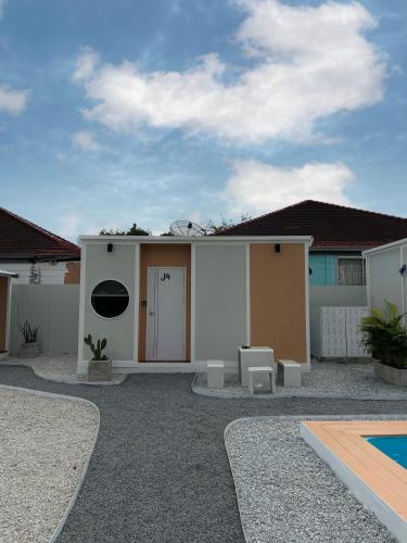 a house with a pool in front of it at JAYLA Resort in Sattahip