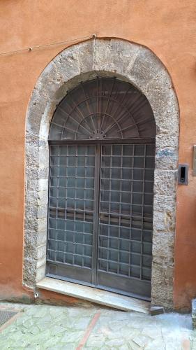 een groot raam met een metalen hek in een gebouw bij La Casetta di Cri in Todi