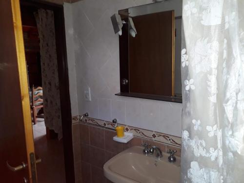 a bathroom with a sink and a mirror at Solares LOFT in Mina Clavero
