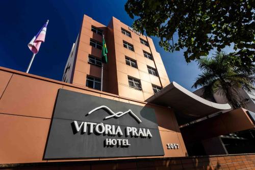 a sign for a hotel in front of a building at Vitoria Praia Hotel in Vitória