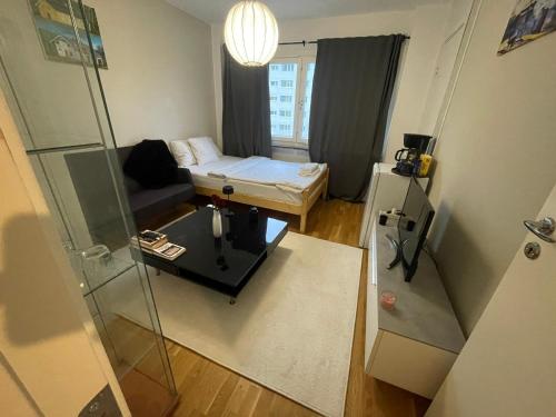 a small room with a bed and a glass door at Private Room in Uppsala in Uppsala