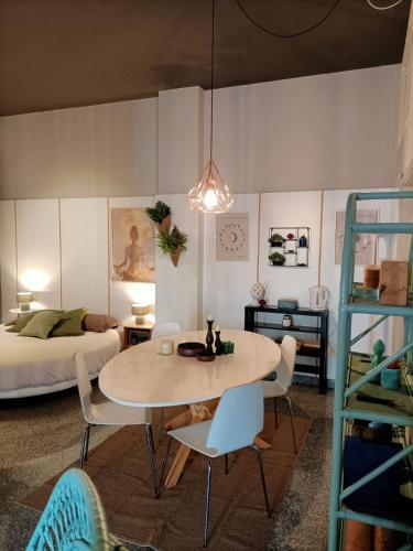 a room with a table and chairs and a bed at Cerchio di Luce in Locorotondo