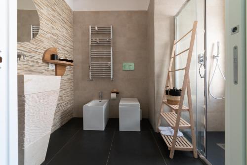 een badkamer met 2 witte toiletten en een ladder bij Namuri Catania Centro in Catania