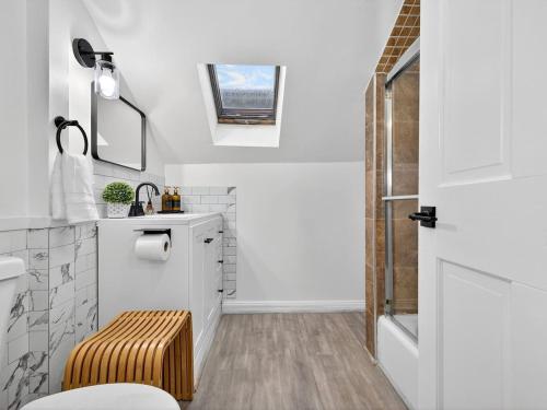 a bathroom with a toilet and a sink at The Harvard Loft with Game Room and Free Parking Near Harvard Square in Cambridge