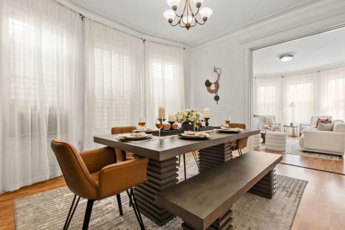 a living room with a dining table and chairs at The Caleb Loft near Manhattan with NYC skyline view in Hoboken