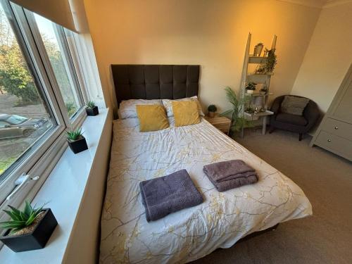 een slaapkamer met een groot bed met twee kussens bij Canal Side Retreat in Heybridge