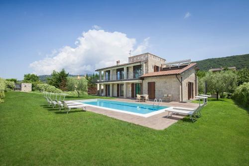 a house with a swimming pool in the yard at Ca Bosca - Fine Living in Torri del Benaco