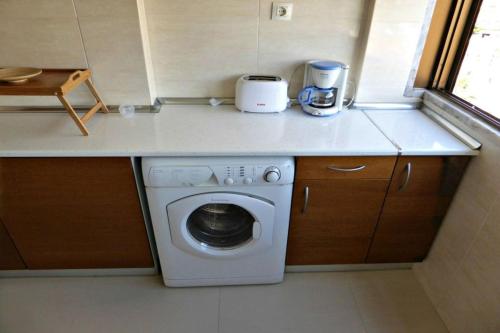 a washing machine in a small kitchen with a counter at Apartment with 2 bedrooms in Infantado in Loures in Loures