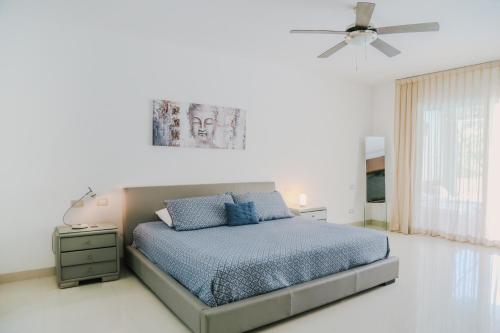 a bedroom with a bed and a ceiling fan at Stunning Ocean Front By Condo Boutique in Playa del Carmen