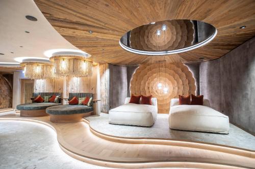 a hotel room with two beds and chandeliers at Verwöhnhotel Kristall in Pertisau