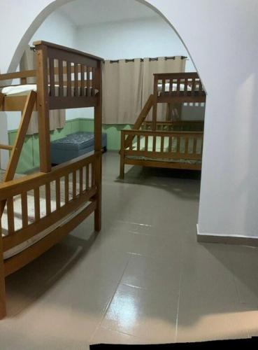 two bunk beds in a room with an archway at Chácara Ana Clara in Cotia