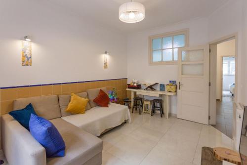 a living room with a couch and a table at 1-Bedroom Flat with Terrace, near Metro & Arena in Lisbon