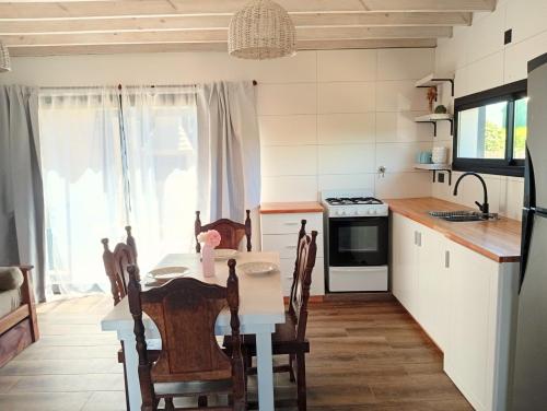 a kitchen with a table and a dining room at Mardel Chapla in Colonia Chapadmalal