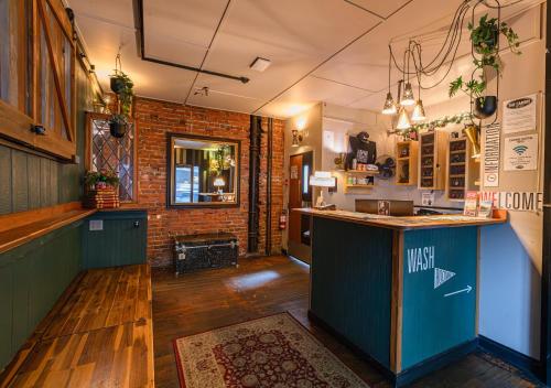 a kitchen with a counter and a brick wall at The Cambie Hostel Seymour in Vancouver