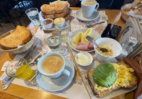 a table topped with breakfast foods and a cup of coffee at Casa Mirador Pichilemu in Pichilemu