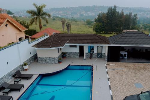 an aerial view of a house with a swimming pool at Dorlan Hotel in Kigali