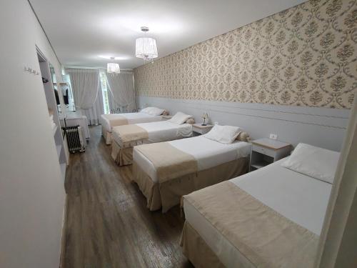 En eller flere senge i et værelse på Pousada Serrano Village - 2km do Capivari