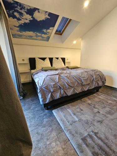a bedroom with a bed with a painting on the ceiling at Central Apartment in Radstadt