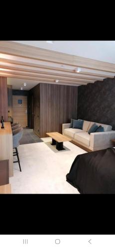 a living room with a couch and a table at WOODSIDE SPA AND PARKING 323 Kopaonik011 in Kopaonik