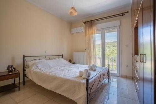 a bedroom with a bed with two teddy bears on it at Villa Dreamy View in Agia Ermioni
