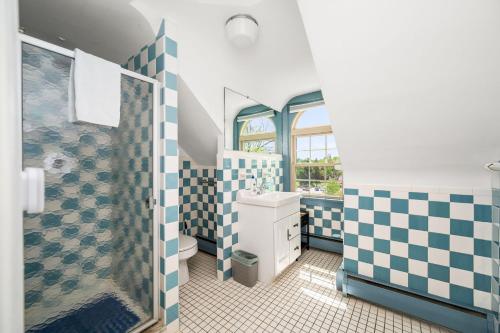 a bathroom with a shower and a toilet and a sink at Downingtown Manor - 1900s Farmhouse with Creek Views in Downingtown