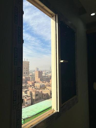 an open window with a view of a city at Egypt Love in Al Badrashayn