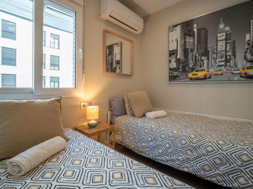 a bedroom with a bed and a couch and a window at Apartamento Luis de Vargas in Huelva