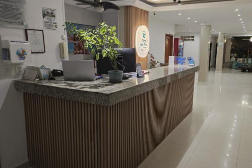 a lobby with a counter with a laptop on it at Olas del Mar Hotel by GHO Hoteles in Santa Marta