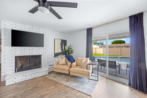 a living room with a fireplace and a tv at Private Pool Haven Backyard & Putting Green in Phoenix