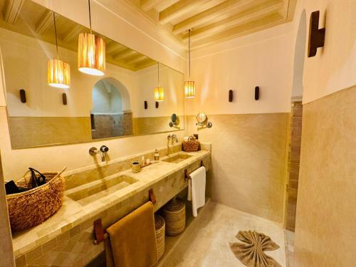 a bathroom with a sink and a mirror at Riad Jardin Des Sens & Spa in Marrakech