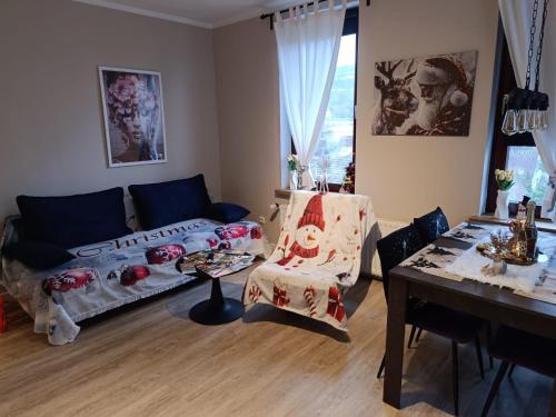 a living room with a couch and a table at Jessis Harz Appartements in Sankt Andreasberg