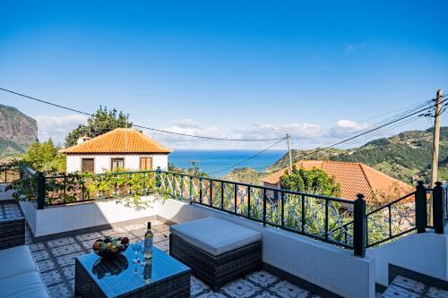 a villa with a balcony with a view of the ocean at Picturesque stay Porto da Cruz in Porto da Cruz