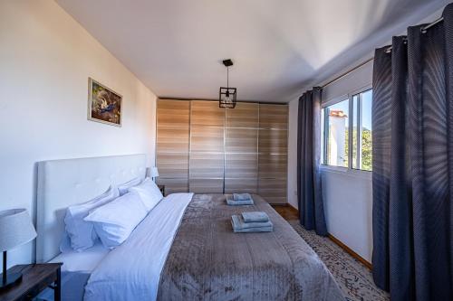 a bedroom with a large bed and a window at Picturesque stay Porto da Cruz in Porto da Cruz