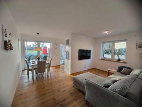 SeeZeitApartments Whg 30 في ليمبروتش: غرفة معيشة بها أريكة وطاولة