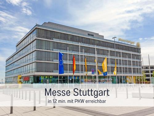 a large building with flags in front of it at Casa Viola Filderstadt, 2 Zimmer, komplett renoviert, top für Familien und Geschäftsreisen, super ausgestattet, PKW Stellplatz in Filderstadt