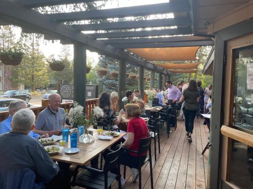 a group of people sitting at tables in a restaurant at Station House Inn South Lake Tahoe in South Lake Tahoe