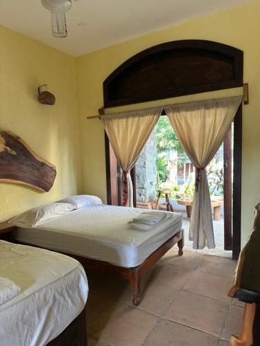 Ένα ή περισσότερα κρεβάτια σε δωμάτιο στο Casa Nhisdao