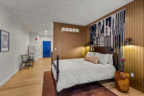 a bedroom with a bed with a large poster on the wall at The Optimist Guesthouse | 3 in Camden