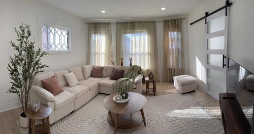 a living room with a couch and a table at Stylish 3BR Revere Home Sleeps 8 Near Boston, Revere Beach and Airport in Revere