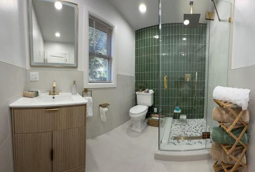 a bathroom with a toilet and a sink and a shower at Stylish 3BR Revere Home Sleeps 8 Near Boston, Revere Beach and Airport in Revere