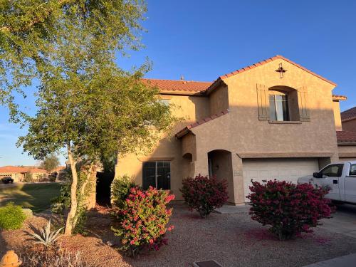 a house with a car parked in front of it at West Phoenix Mini Master Bennet in Phoenix
