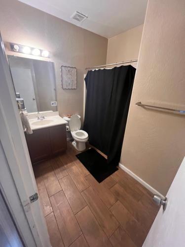 a bathroom with a toilet and a sink and a shower at West Phoenix Mini Master Bennet in Phoenix