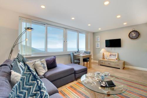 a living room with a couch and a table at 1 Bed in Limeslade oc-hh387 in The Mumbles