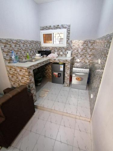 a small kitchen with a counter and a sink at Résidence hibis chez M&B in Saly Portudal