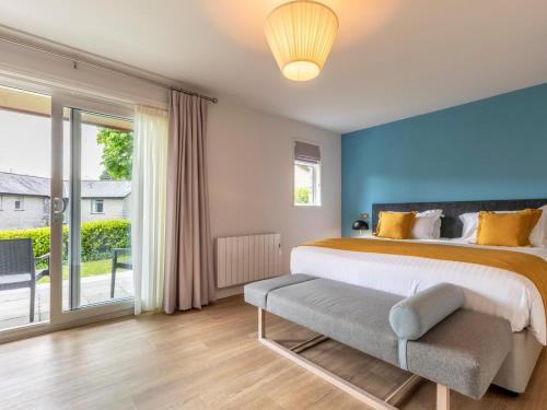 a bedroom with a large bed and a large window at 2 Bed in Saltash oc-87712 in St. Mellion