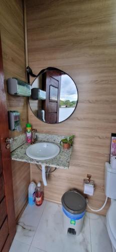 een badkamer met een spiegel, een toilet en een wastafel bij Casa Flutuante em Manaus - Amazonas in Manaus