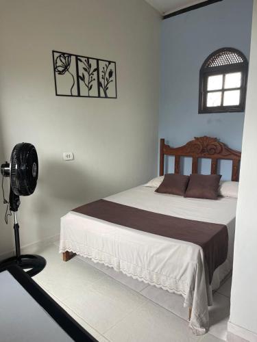 En eller flere senge i et værelse på Raízes Pousada