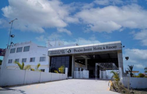 a large white building with a fence in front of it at Prachi Shree Hotel and Resort in Badnāwar